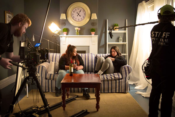 NYFA Australia students and staff working and acintg in a living room set