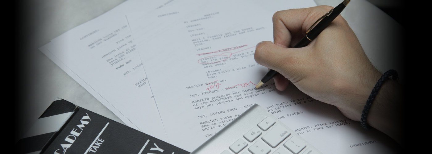 Hand writes notes in red pen on a screenplay